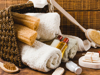 A basket with towels, loofah, and soap
