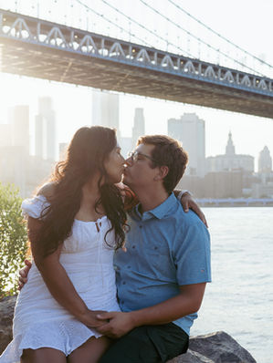Romantic couple photoshoot in DUMBO, Brooklyn, with the Manhattan Bridge in the background.