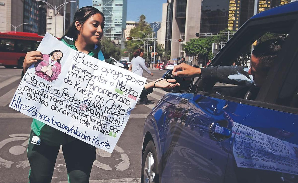 The karate athlete, Alondra Mendez, asks for money during a red light.