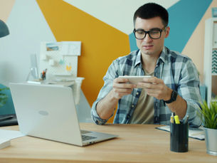 A man playing on a mobile phone