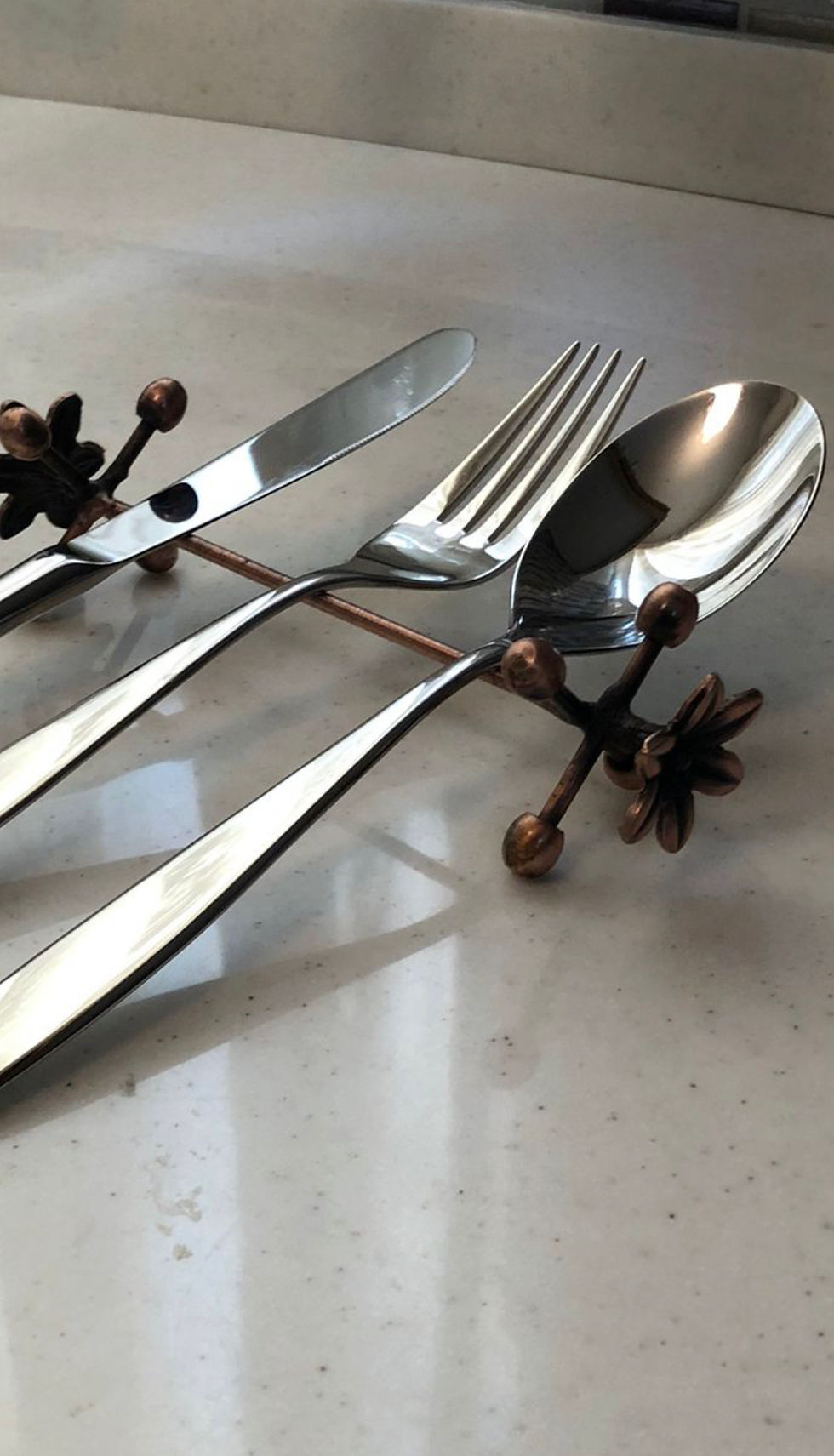 Thumbnail: Top view of a brass finish cutlery holder with assorted cutlery.