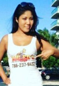 Woman Promoting Big Ed Auto Rescue: A smiling woman wearing a Big Ed Auto Rescue tank top, pointing at the company's contact