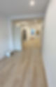 Transformation of space with fresh flooring, recessed lighting, and a modern open-concept layout.