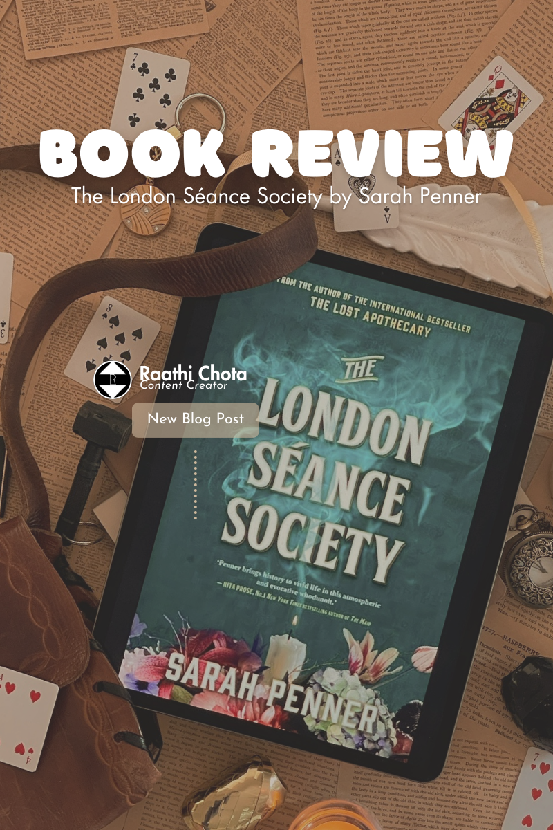 Tablet showing "The London Séance Society" book cover, surrounded by playing cards, vintage papers, and a watch, creating a mystical vibe.