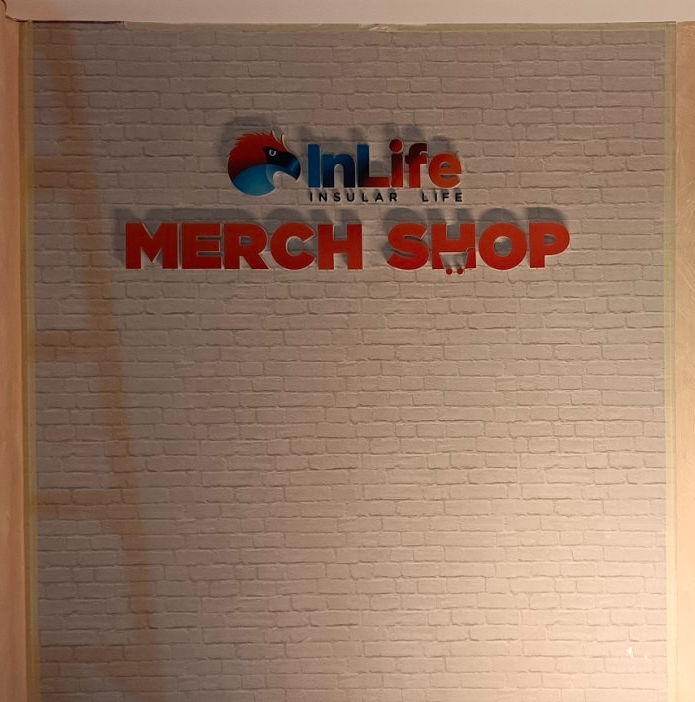 InLife Merch Shop logo on a brick wall at Grass Residences