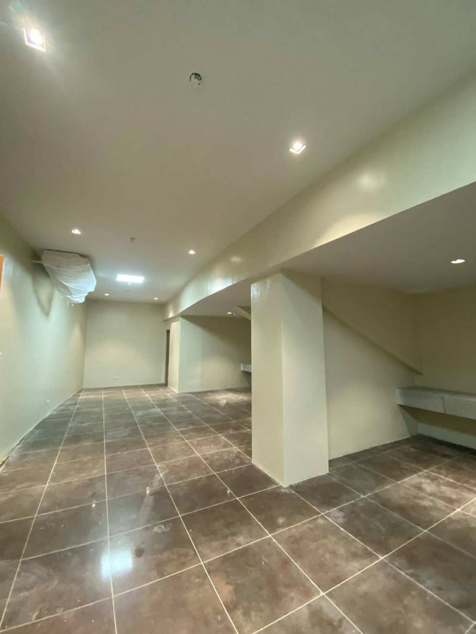 Modern empty basement room with tiled flooring and AA2000.