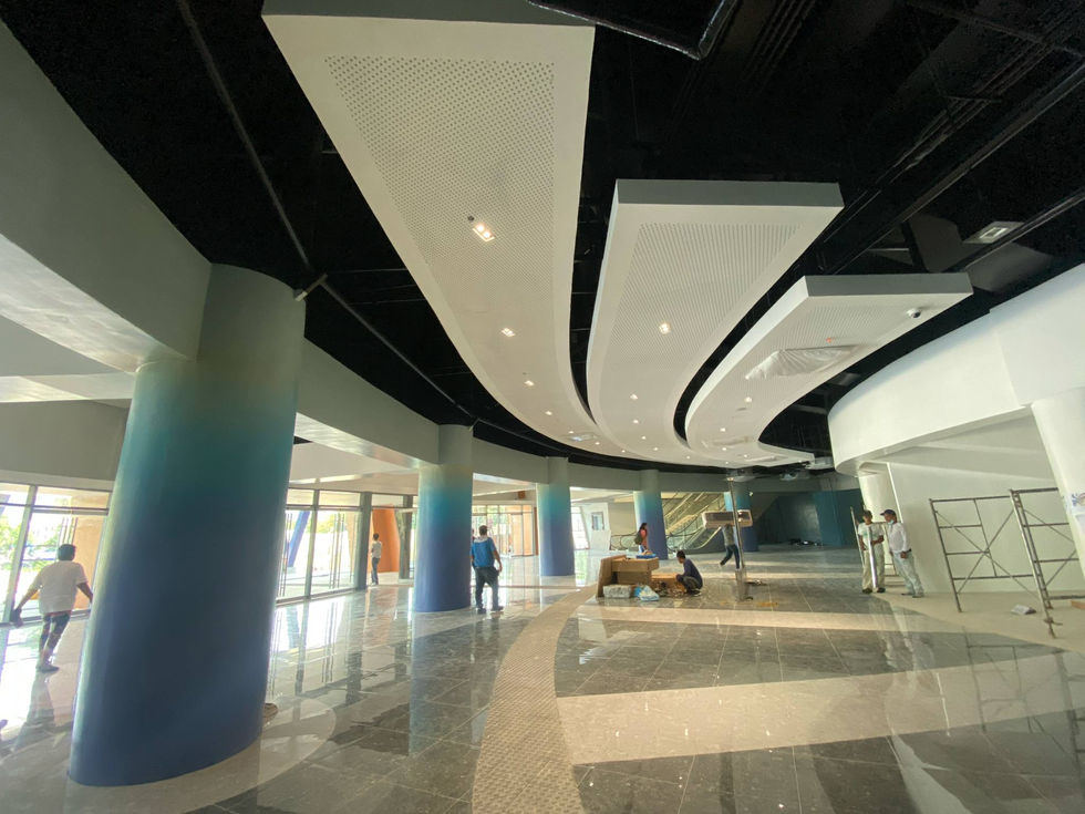 Modern building lobby with curved ceiling panels and AA2000 installation.