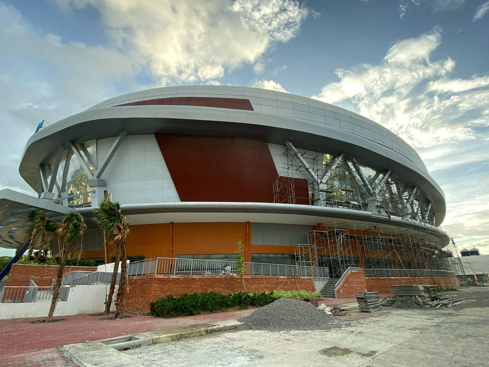 Modern AA2000 stadium with curved roof and red facade