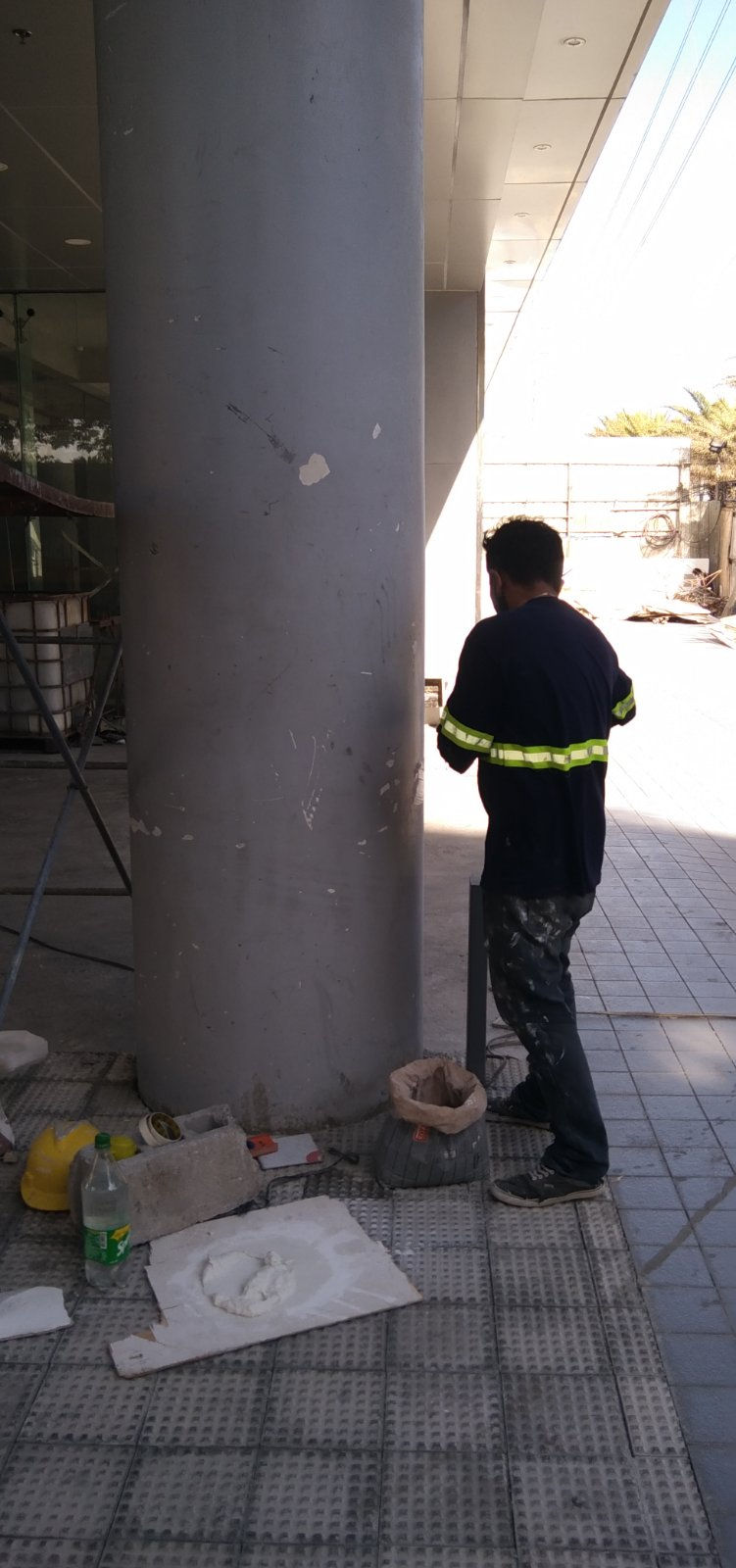 Worker in safety gear at Grass Residences construction site