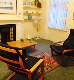 Colour photo of two black leather chairs facing each other