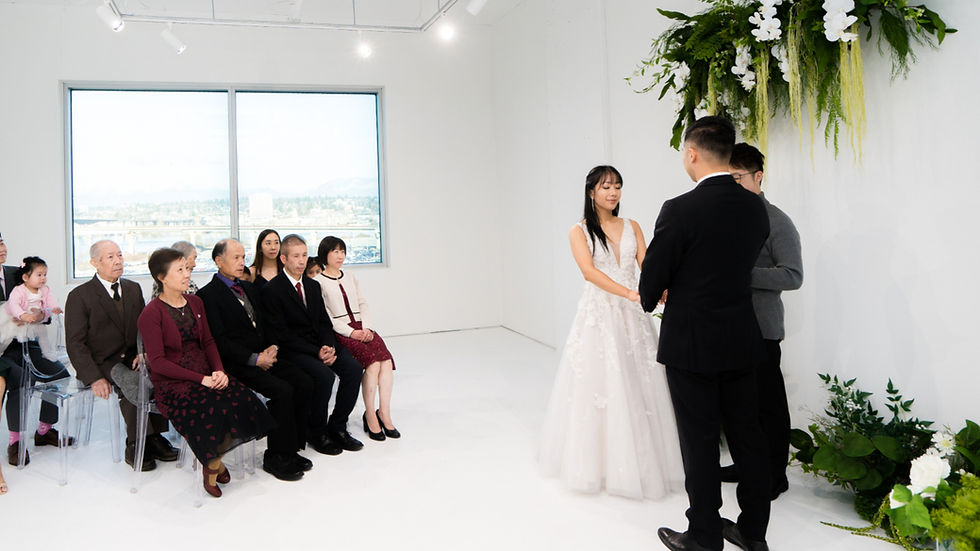 Couple exchanging vows during an indoor micro wedding ceremony with close family present at The Ensora near Vancouver.