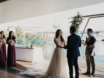 Couple exchanging vows during a Classic Celebration wedding ceremony at Polygon Gallery in North Vancouver, BC.