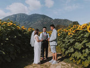 Couple exchanging vows during an intimate sunflower field elopement ceremony in Chilliwack with a wedding officiant