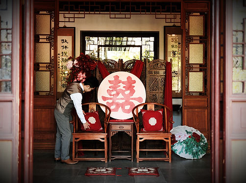 Wedding officiant preparing a traditional Chinese tea ceremony setup in Vancouver as part of a guided ceremony experience