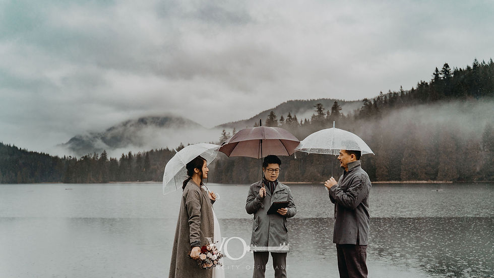 intimate lakeside elopement ceremony in Vancouver with mountains and rain