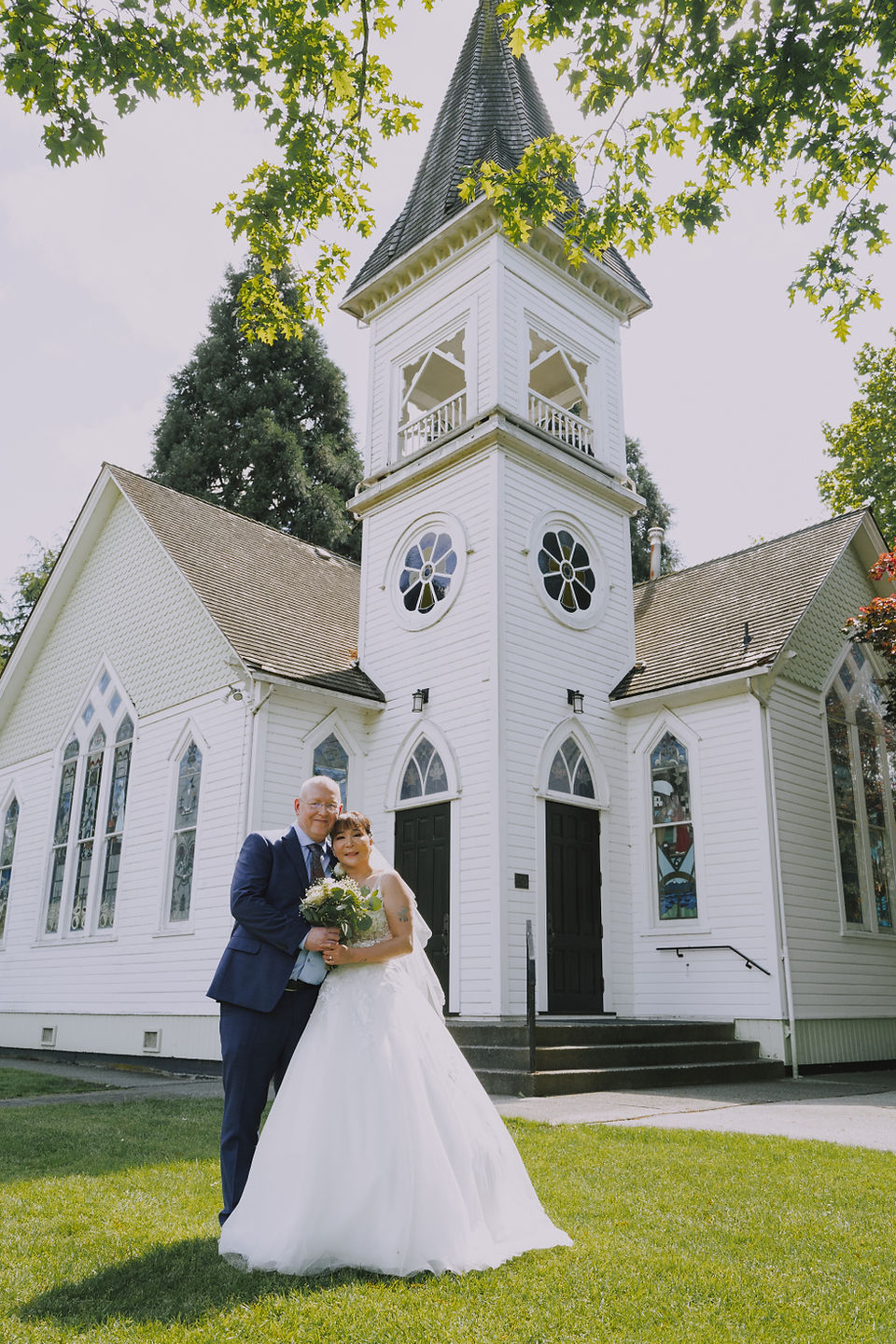 Couple standing outside a chapel-like ceremony setting at Minoru Park in Richmond, BC