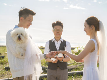 Couple exchanging rings during a pet-inclusive wedding ceremony with their dog present as part of the moment in Vancouver BC
