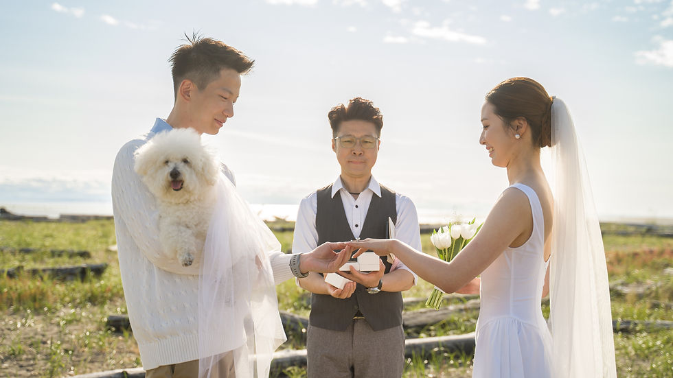 Couple exchanging rings during a pet-inclusive wedding ceremony with their dog present as part of the moment in Vancouver BC
