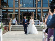 Bride walking down the aisle during a wedding processional at a modern ceremony