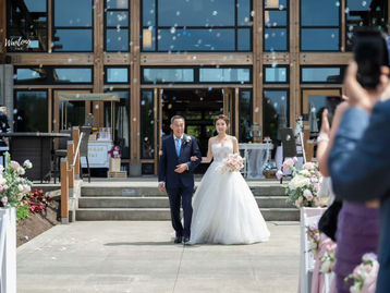 Bride walking down the aisle during a wedding processional at a modern ceremony