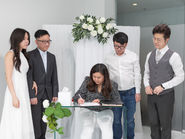 couple signing marriage licence during indoor legal signing ceremony at The Ensora in Richmond Vancouver