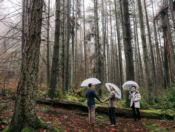 visitor elopement ceremony in Vancouver forest with officiant and couple