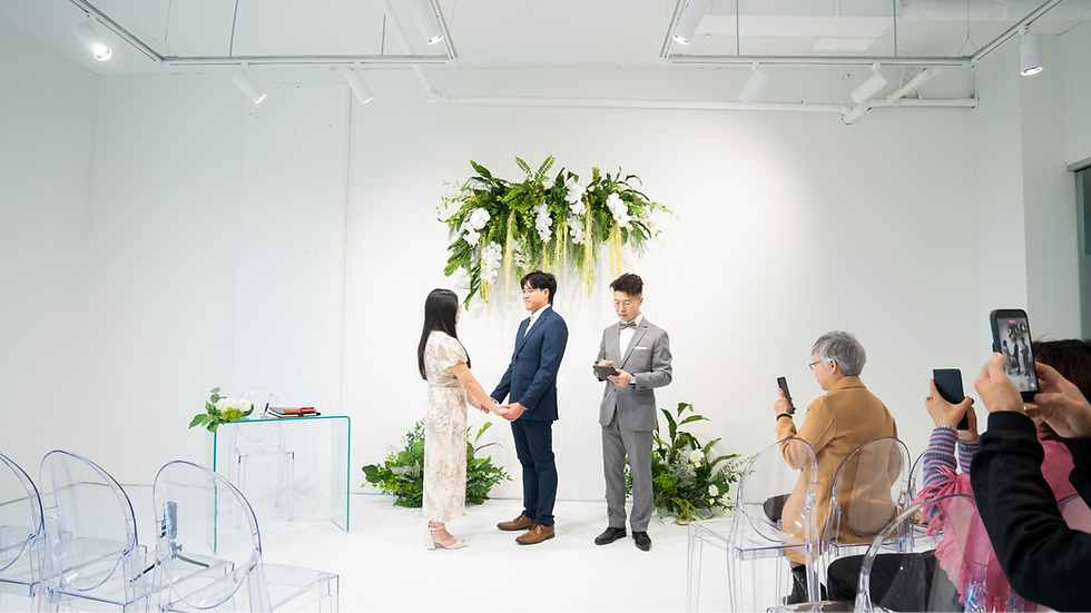 Couple participating in a legal signing ceremony with a marriage officiant and witnesses in British Columbia