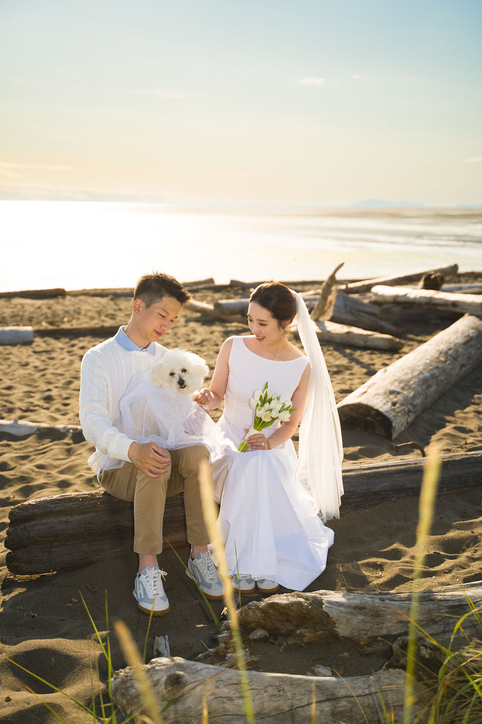 Couple sitting together at Iona Beach after an outdoor elopement near Richmond, BC