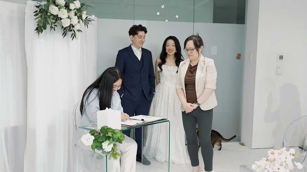 Couple completing legal marriage paperwork during a ceremony at The Ensora in British Columbia