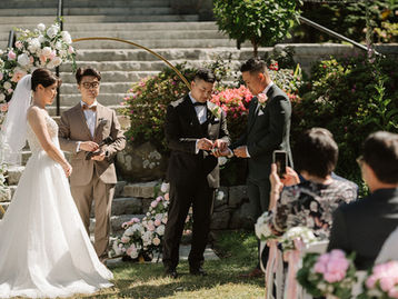Guest holding up a phone during an outdoor wedding ceremony guided by a Vancouver marriage officiant