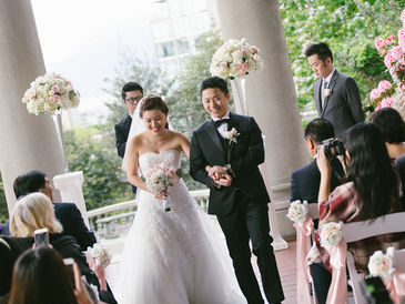 Newly married couple walking down the aisle during a wedding recessional at a modern ceremony