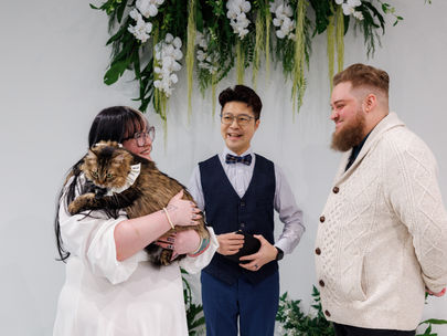 Intimate indoor micro wedding at The Ensora in Vancouver, BC with a couple, officiant, and their cat included in the ceremony.