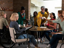 Adults of different ages sharing conversation over tea at a Mindset Vitality Bereavement Friendship Group in Swansea and Neath Port Talbot.