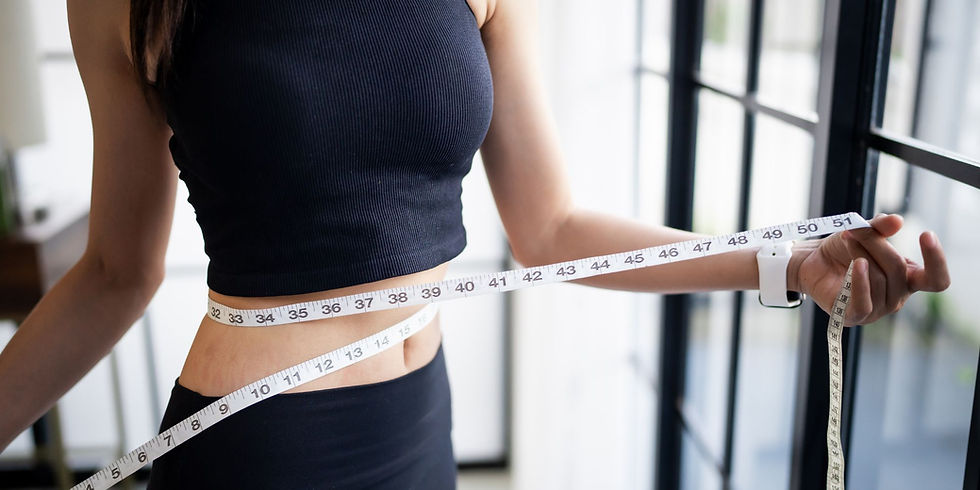 Woman measuring her waist for medical weight loss in Elkton, MD.