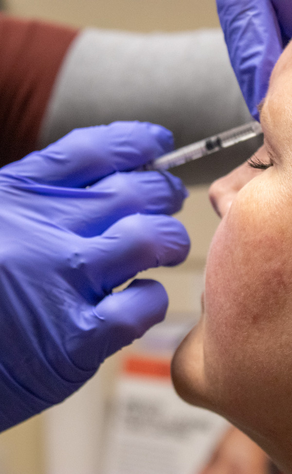 Jocelyn Dill providing a facial cosmetic injection