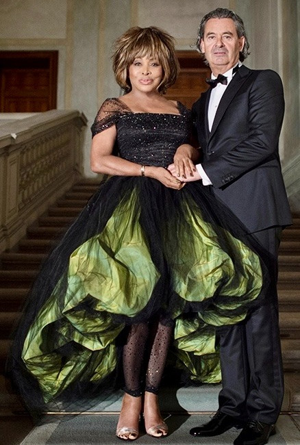 Tina Turner at her 2023 wedding in a black and green dress.