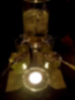 absinthe fountain with only a candle illuminating it