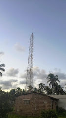 What is the Coverage of a Community Radio Station with 25 to 100 Watts and a 30-Meter Tower?