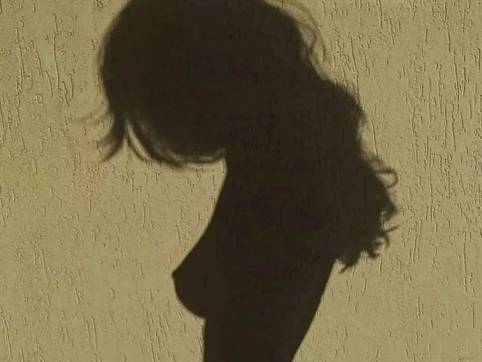 Shadow of a person with long hair on a textured beige wall. No visible text. The mood is calm and introspective.