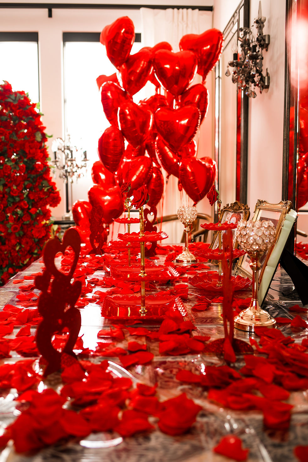 Red heart balloons and petals, event planning services, Sienna Sinclaire Studios.