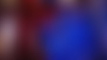 How To Photograph Mannequins: Cinematic mannequin photoshoot in a red British phone booth at night, model in black lingerie fixing her heel under moody lighting with blue and red tones