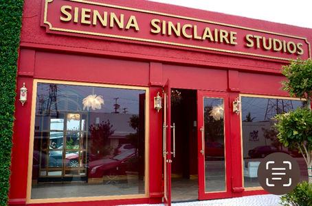 European-style red storefront studio in Burbank / North Hollywood featuring arched red walls, gold crystal and feather chande
