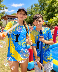 Children enjoy outdoor play with bubbles at Leaps & Beats camp.