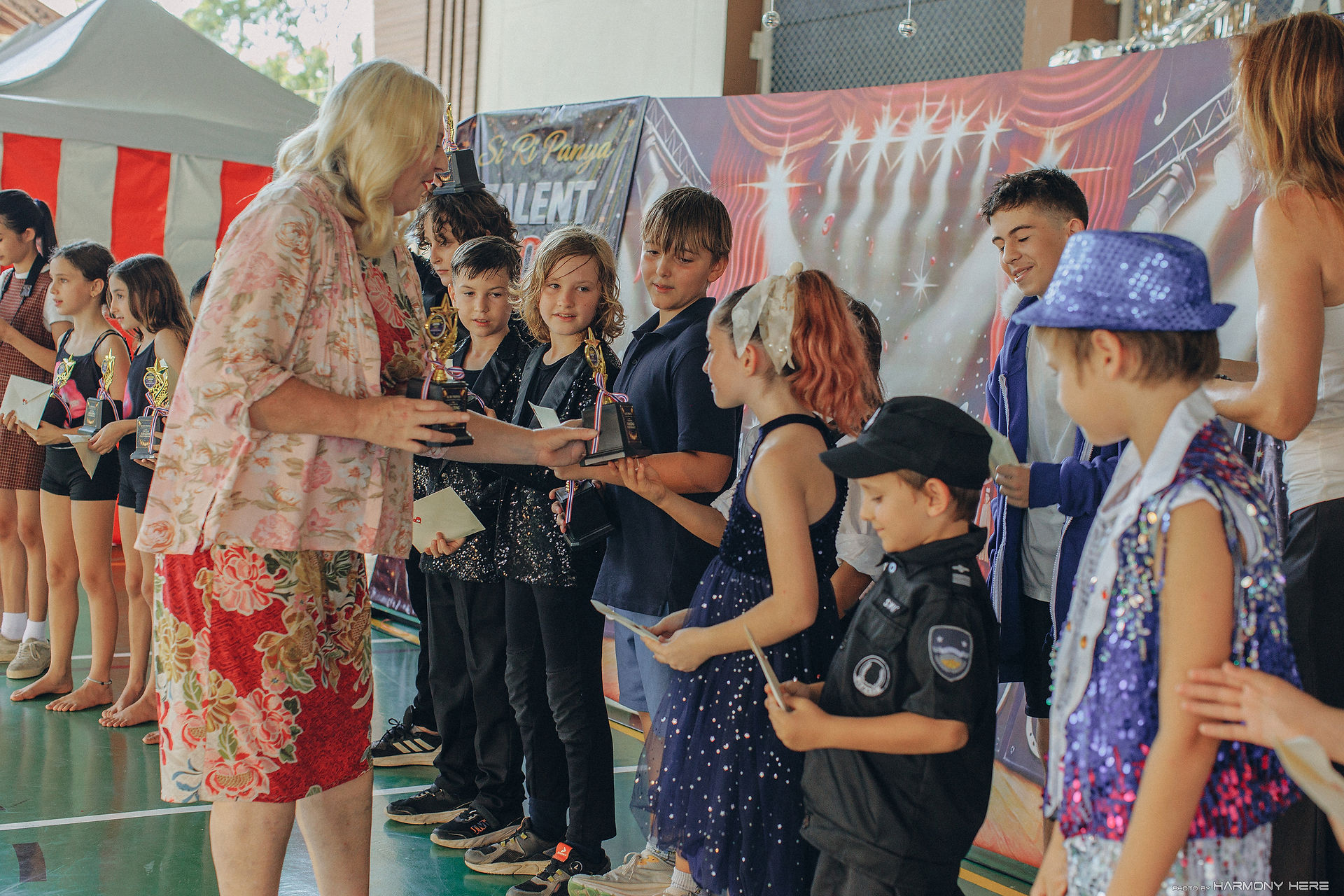 Students receiving awards at Si Ri Panya News Highlights event.