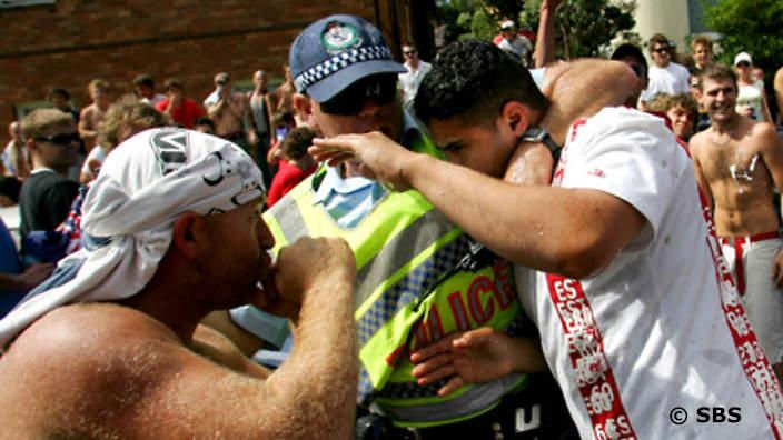 A police officer protests a victim in Cronulla's summer of simmering tension which boiled over into race riots in 2005