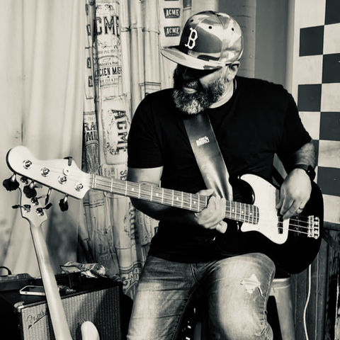 Artist, Bernard Harris playing bass on stage.