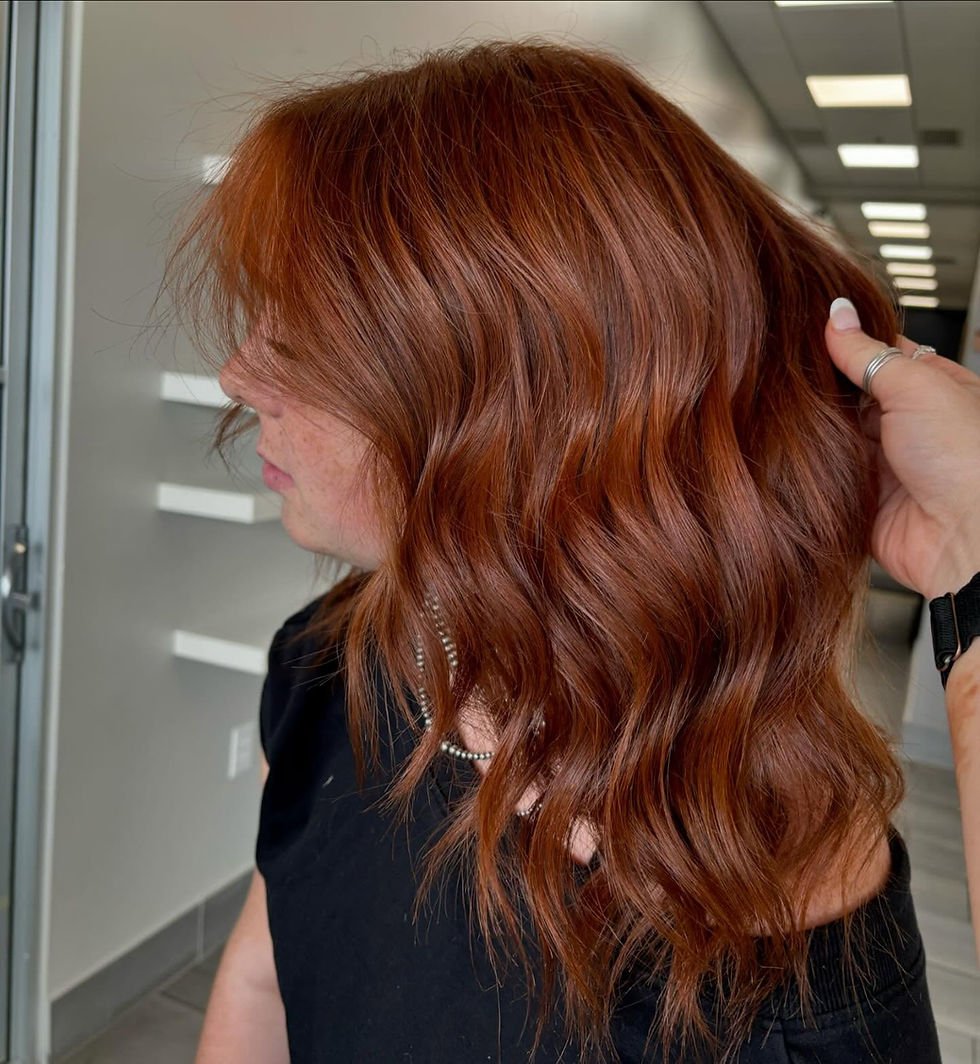 Wavy copper red hair after salon service