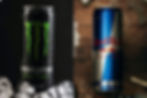 DRINK. This is a photo of the infamous energy drinks Monster and Red Bull, the rivalry between them is big. There is more information on both of them and why one is better than the other.  Photo courtesy of Corner Coffee Store.