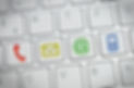 colored contact us icons on a white keyb