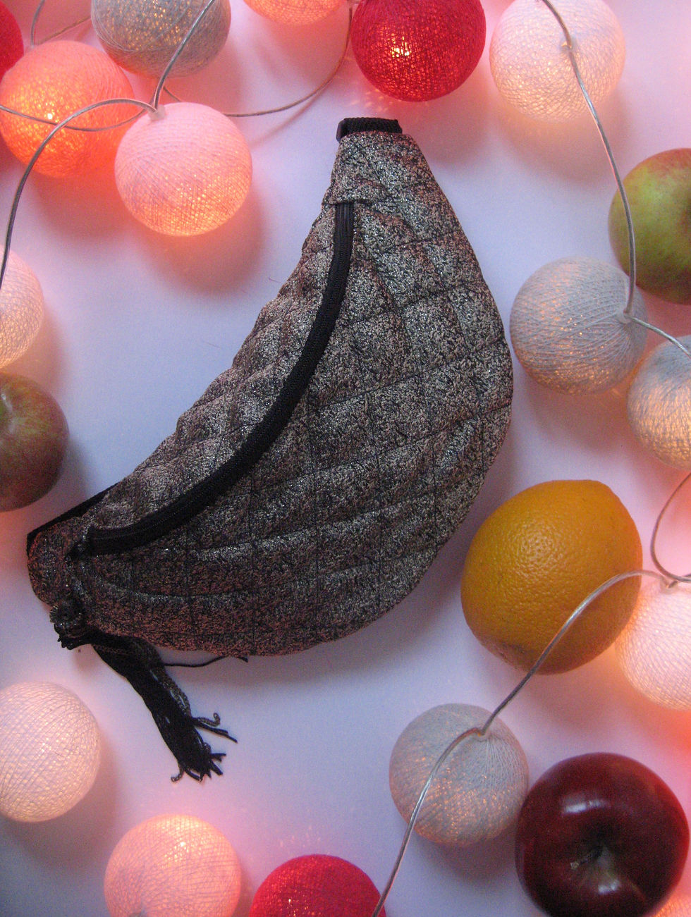 Waist bag in gold on the table